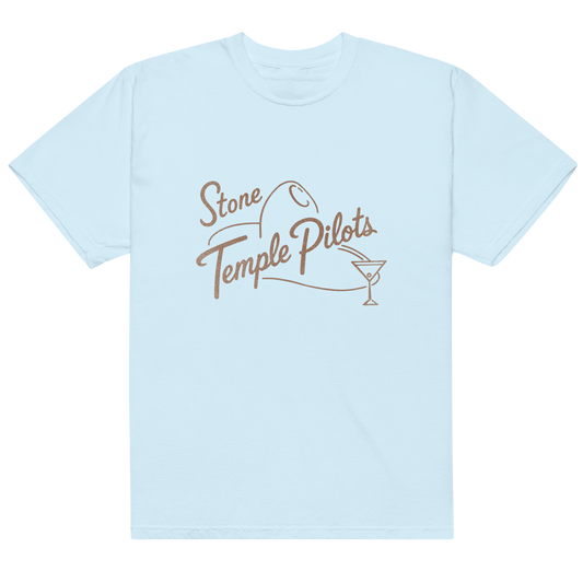 A light blue crewneck t-shirt with a brown graphic on the chest reading 'Stone Temple Pilots' alongside a small motorcycle and martini glass illustration.