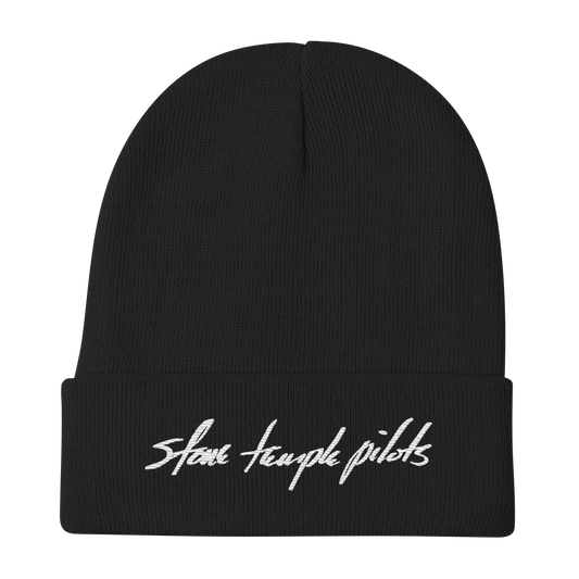A black ribbed knit beanie hat with a folded cuff featuring the words 'Stone Temple Pilots' embroidered in white script across the front, shown on a plain white background.